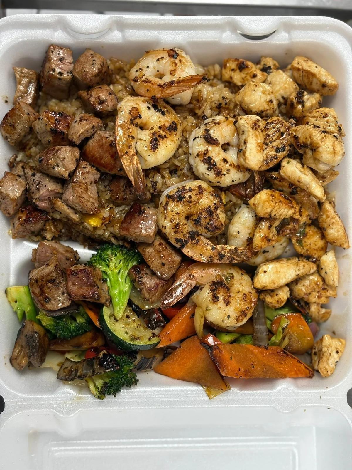Hibachi steak, chicken and shrimp with fried rice and vegetables